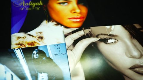 Rome, Italy - March 26, 2019: CDs and artwork of the American singer, actress, and model Aaliyah. Billboard lists her as the tenth most successful female R&B artist of the past 25 years