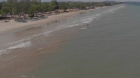 Aerial view of ocean waves crashing on Beautiful beach by, 4K drone footage at Sabandar Beach, Tuaran, Sabah, Malaysia