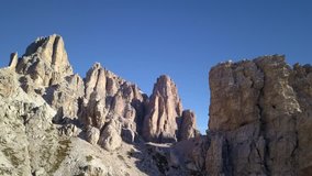 Spectacular drone aerial video in Dolomites at summer time in the Lagazuoi mountains near Cortina D'Ampezzo and Passo Falzarego.