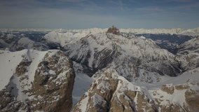 Spectacular drone aerial video near Cortina D’Ampezzo of Dolomites from the top of Cristallo mountain in winter.
