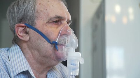Senior Man Inhales with Face Mask of Nebulizer