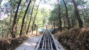 Tourist are happy and enjoying the view during using Ground Glider Chairlift at Kunming City, China - Powered by Shutterstock - Get 15% off with code: PIKWIZARD15