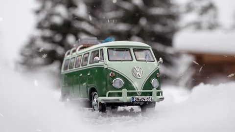 STRBSKE PLESO, SLOVAKIA - JANUARY 08 2019: Volkswagen Transporter T1 / Volkswagen T1 / Volkswagen Bus / Volkswagen Bulli with skis and luggage on the roof rack on snowy road. Scale model 1:43.