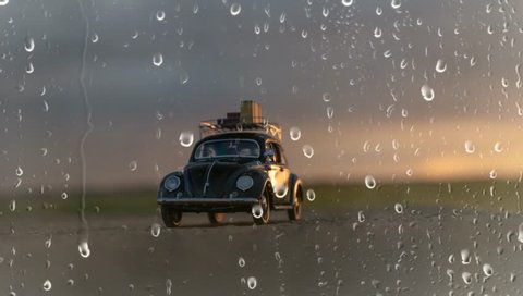NITRA, SLOVAKIA - JUNE 28 2018: Volkswagen Beetle with suitcases on the roof. Summer rain and Volkswagen Beetle. Classic car VW Beetle by rain.