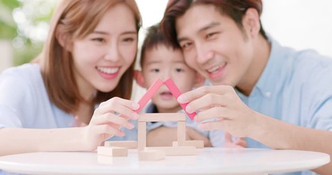 happy asian family playing with toy blocks