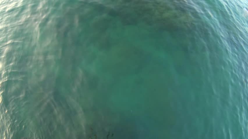 Jumping PoV (Slow Motion Action Camera) from rock into sea underwater and emerged with a sunset view. Sports Lifestyle Hobby Vacation Leisure Activity 