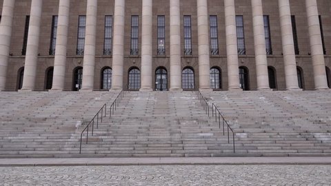 Camera tilting up on the outdoor stairs of the Parliament House of Finland