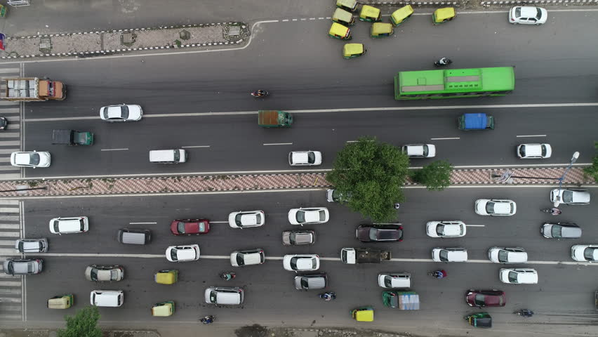 Heavy traffic moves along river,railway yard delhi shanti stupa road in the heart of new delhi business district in India capital city. Royalty-Free Stock Footage #1026492833
