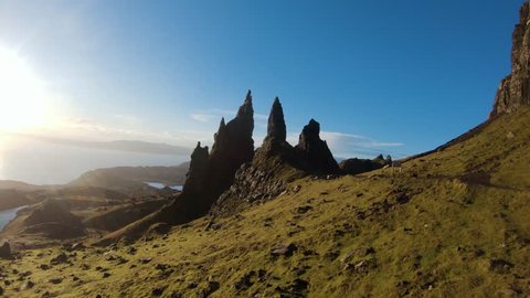 Fast slow motion fly towards and through Old Man Storr rock formation.