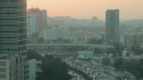 Shot of the metropolitan City Karachi in Pakistan. Cars, trucks, buses, rickshaws, high rise buildings all part of the busiest city in the country.