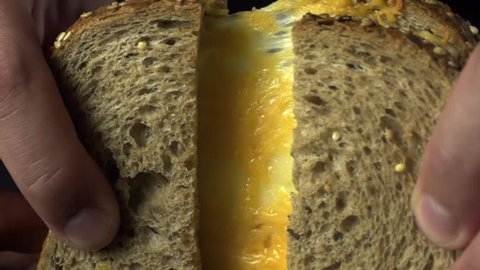 Dark Bread Sandwich with Cheddar Cheese, cooking in slow motion