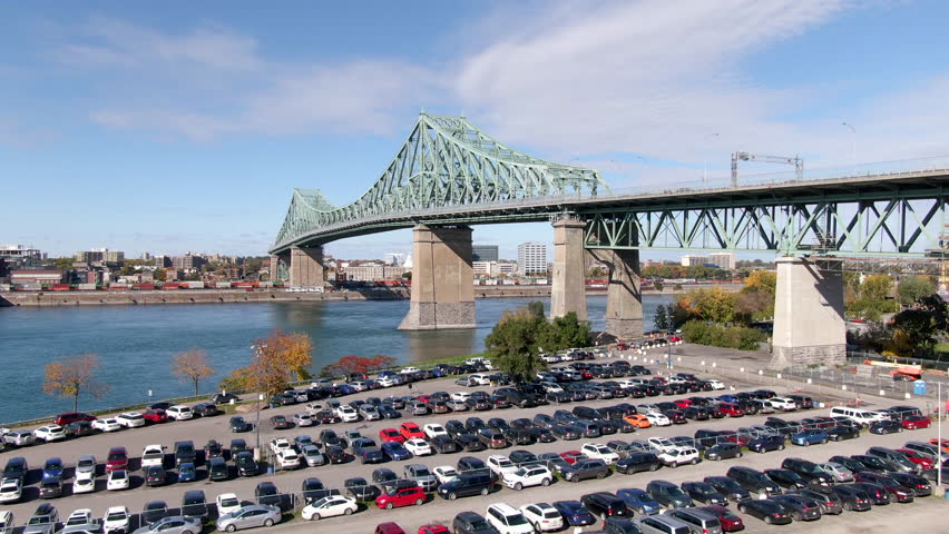 Montreal, Quebec, Canada, aerial view of architectural landmark Jacques Cartier bridge over the Saint Lawrence river, dolly up. 