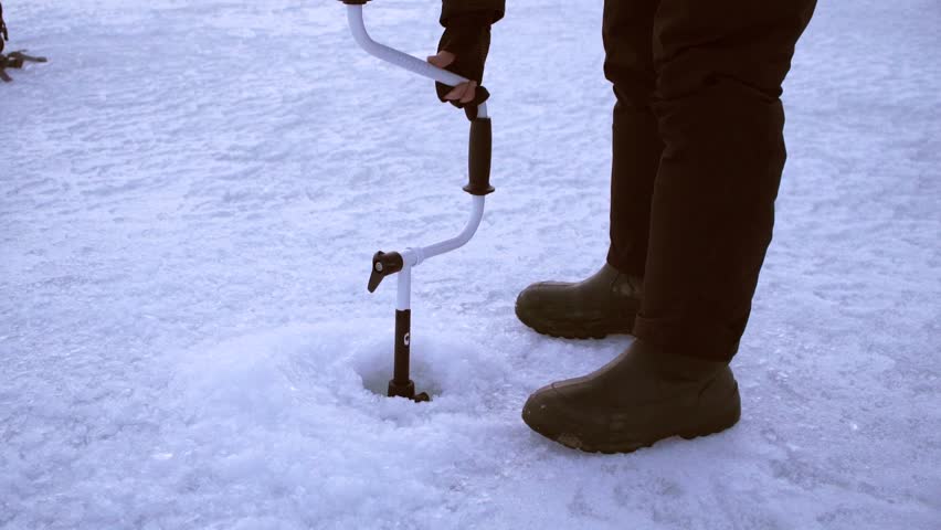 angler drills the hole and sprinkles water