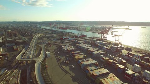 Seattle Aerial v5 Flying low panning right over large shipyard with Puget Sound views. 3/15