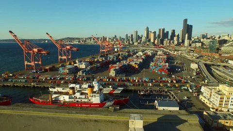 Seattle Aerial v1 Flying low over large shipyard port with cityscape and waterfront views. 3/15