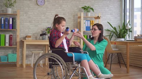 doctor and child in wheelchair rehabilitation therapy