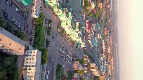 Vertical video. Russia, Omsk - July 16, 2018: The central railway station of the city of Omsk. The building of the station. Sunset, From Drone