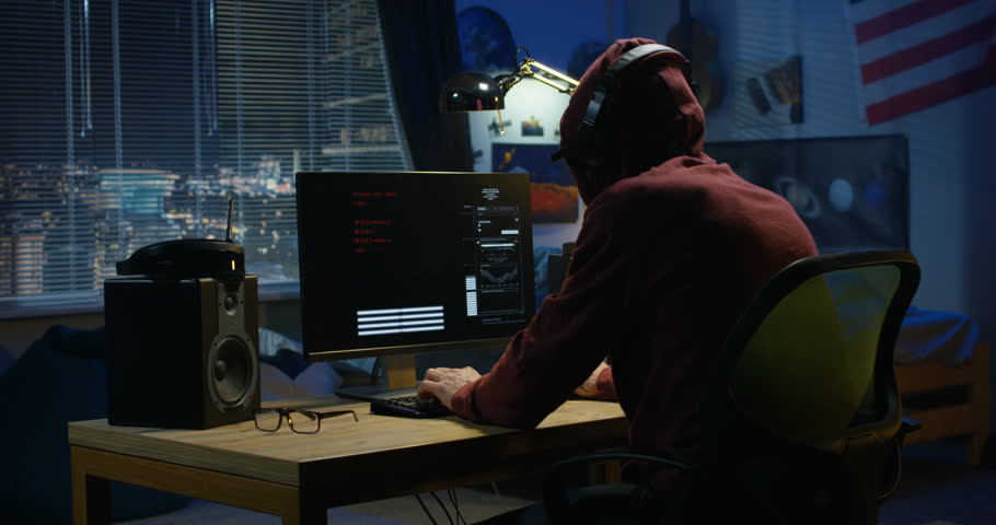 Medium shot of a programmer coding on his computer at night | Shutterstock HD Video #1026548972