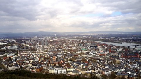 The city of Mainz in an aerial hyper lapse. The capital of the state Rhineland Palentina is shown in a wide shot from high above including the cathedral, the market place and the bridge.