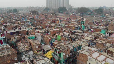 4k aerial view of Indian slum  in a situation of deteriorated, incomplete infrastructure, lacking in reliable sanitation services, supply of clean water, reliable electricity & other basic services. 