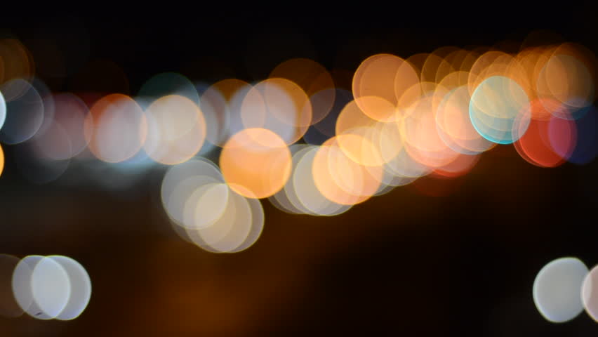 defocused street lights and car headlights at night creating bokeh
