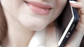 close-up of female lips phone conversation. Smile
