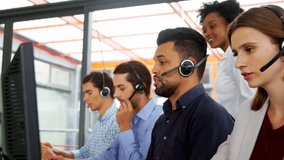 Side view of diverse business executives with headsets using computer in office  - Powered by Shutterstock - Get 15% off with code: PIKWIZARD15