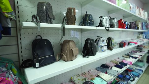 MOSCOW, RUSSIA - CIRCA 2018: Interior of children's clothing store. Kids accessories bags backpacks on shelves.