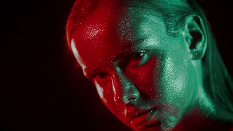 Fashion portrait of woman's face in glitter and under neon lights in 80's style, video portrait with green and red mixed neon on dark background, Shot in high quality prores 422 on Blackmagic Ursa