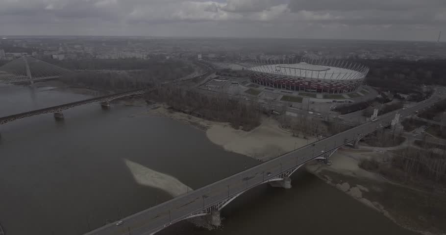 4K. Aerial view of Warsaw Stadium, bridges passing through the river Vistula. The span over the bridge on the Vistula River, the urban landscape overlooking the bridge and the stadium.