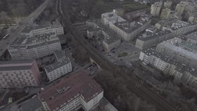 Aerial view of high-speed trains passing through the center of Warsaw. Trains passing through the yellow buildings by the river Vistula. Taken from the drone in RAW  format 4K.