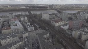 Aerial view of the railway with trains in the center of Warsaw / Poland. Trains passing through the yellow buildings by the river Vistula. Taken from the drone in RAW  format. 4K
