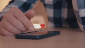 Close up of young man using smartphone with likes and loves icon floating out of smart phone - Powered by Shutterstock - Get 15% off with code: PIKWIZARD15