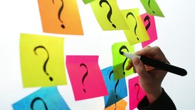Businesswoman writing question marks on colorful sticky note paper on office whiteboard - Powered by Shutterstock - Get 15% off with code: PIKWIZARD15