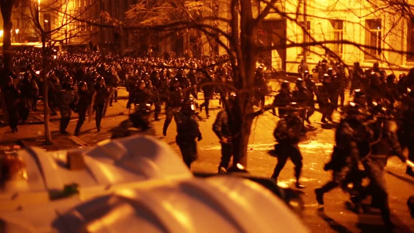 KIEV, UKRAINE - DEC 1, 2013: Riot police (Berkut) attacks protesters on Bankova street near Presidential Administration building