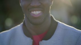 Close-up shot of young Afro-American male mouth smiling. Lifestyle concept