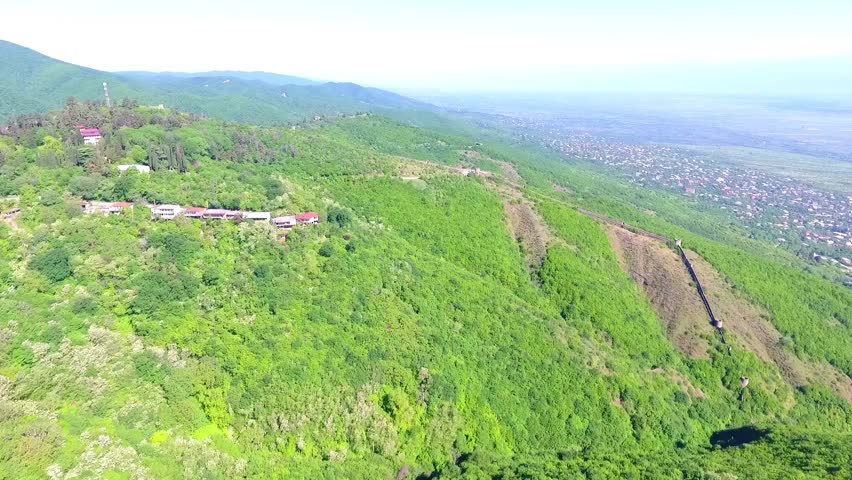 View from the ancient fortress at Sighnaghi, Georgia. A view from above of the landscape of the city and mountains. The clouds float above the mountains. town Sighnaghi