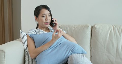 Woman talk to mobile phone at home