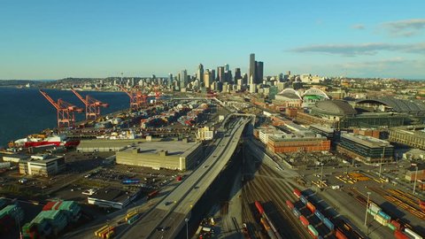 Seattle Aerial v7 Flying low backwards panning right over industrial area with cityscape views. 3/15