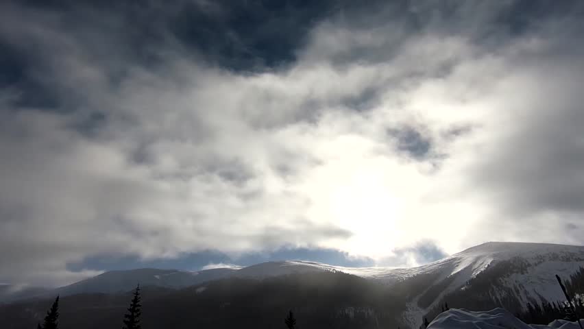 Wonderful Snow Capped Mountains, with Clouds and Sun Mixed with Pine Trees