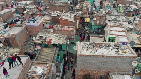 
Slums, Delhi, India, February 19th 2019: 4k aerial view of Indian slum  in a situation of deteriorated, incomplete infrastructure, lacking in reliable sanitation services, supply of clean water...