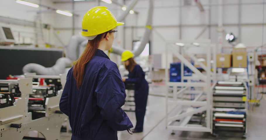 4K Portrait of female factory engineer looking at camera with serious expression