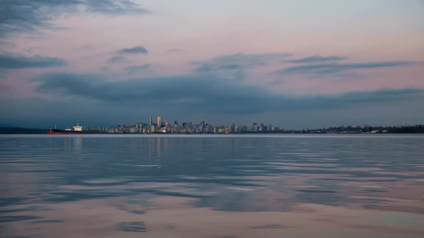 View of Downtown Vancouver Skyline from the water perspective during a vibrant cloudy sunset. Still Image Continuous Animation