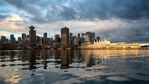 Downtown City viewed from the water during a cloudy sunrise. Taken in Vancouver, British Columbia, Canada.