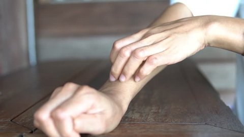 Woman scratches the itch with hand on the table, Concept with Health care And Medicine.
