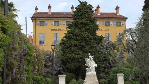 GRASSE, ALPS MARITIMES/FRANCE - APRIL 27, 2015: International perfume museum and Honore Fragonard statue, Grasse old town. The town is considered the world's capital of perfume.