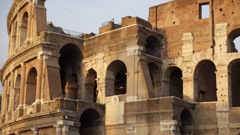 Close up of famous Italian attraction Colosseum in Rome. Veiw on ancient Flavius amphitheater Coliseum in capital of Italy. Camera moving from left to right