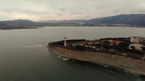 Aerial view panorama of lighthouse on thousand of Gelendzhik city, sea resort at black sea for summer travel and tourism, coastline from drone.