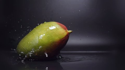 Mango Fruit Falling in Water with Splash in Slow Motion