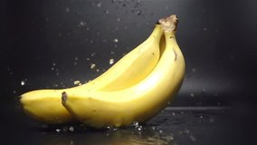 Bananas Falling in Water with Splash in Slow Motion on black background - Powered by Shutterstock - Get 15% off with code: PIKWIZARD15